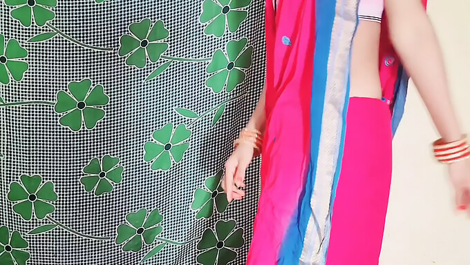 Husband And Wife Share A Pink Saree In Their Bedroom